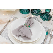 SET VAN 4 GOUDEN SERVETRINGEN MET GROENE DIAMANTEN