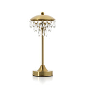Gold table lamp with crystal accents on a white background