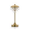 Gold table lamp with crystal accents on a white background