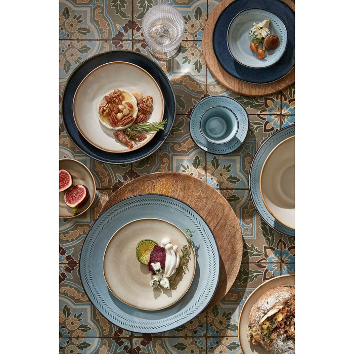 Dinnerware set on a patterned tile surface