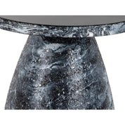 Marble pedestal table with a dark gray and white marbled pattern.