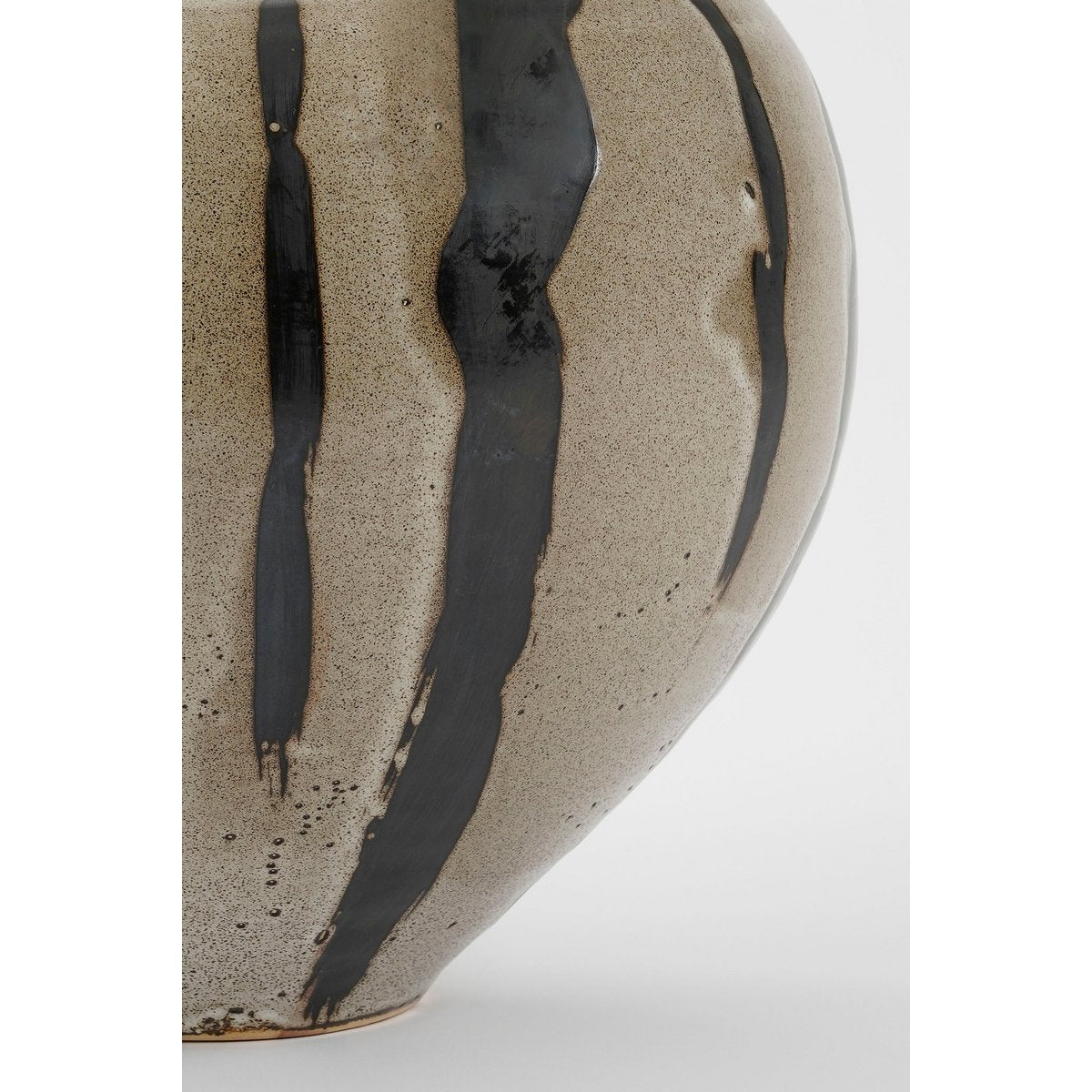 Ceramic vase with black abstract patterns on a white background