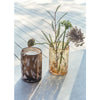 Two glass containers with candles and dried plants on a reflective surface.