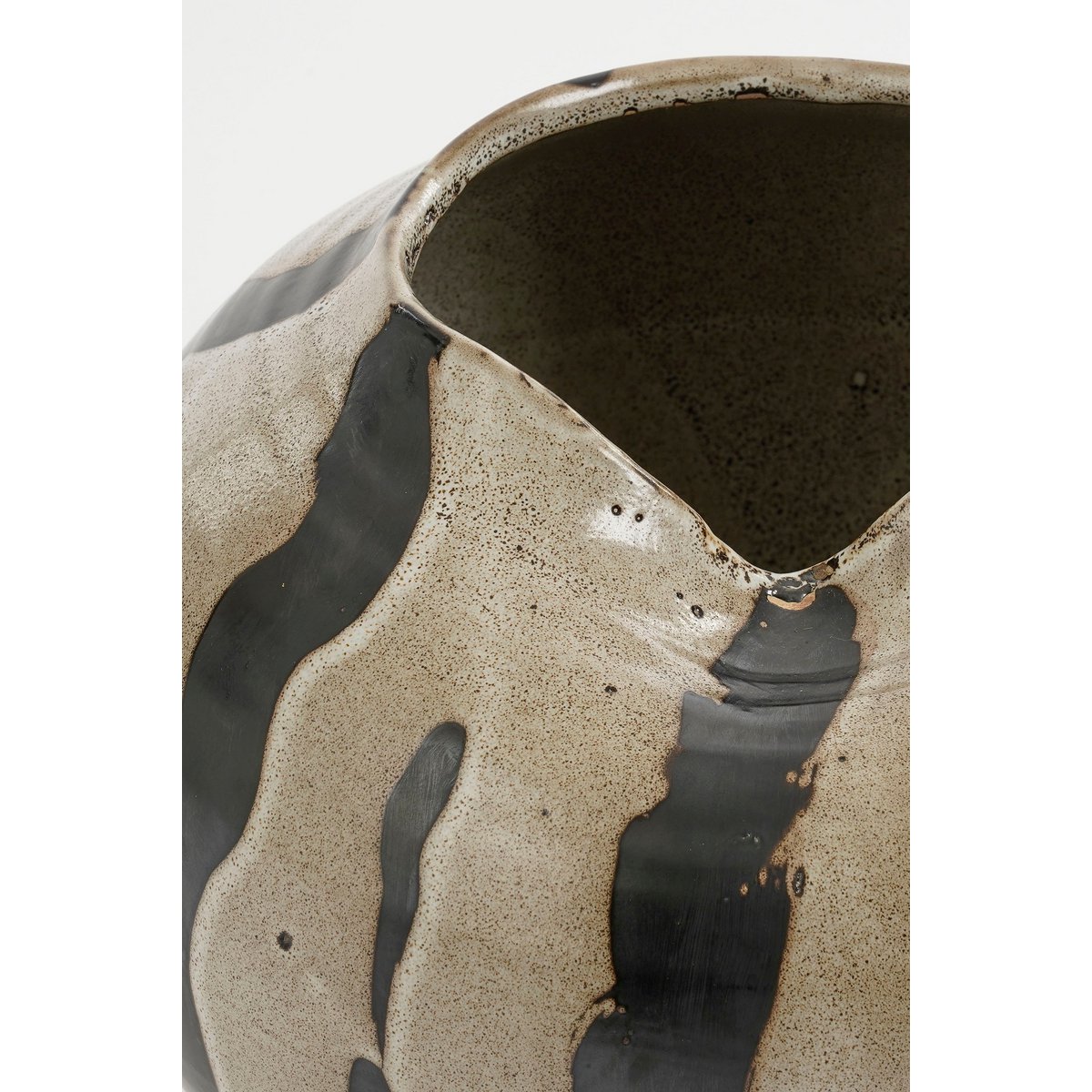 Ceramic vase with brown and black abstract design on a white background