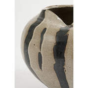 Ceramic vase with black glaze on a white background