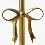 Gold bow-shaped object on a white background