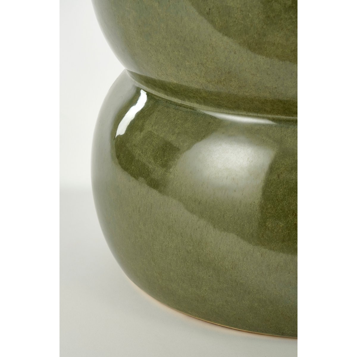 Green ceramic vase on a white background
