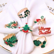 SET VAN 4 GOUDEN SERVETRINGEN MET GROENE DIAMANTEN